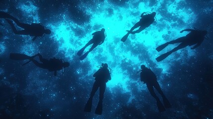 Fototapeta premium Silhouetted Divers Exploring a Glowing Deep Ocean