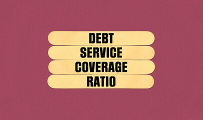 DSCR Symbol. Concept word DSCR Debt Service Coverage Ratio on beautiful wooden stick. Beautiful Pink Chart Paper Background. Business and DSCR Debt Service Coverage Ratio concept. Copy space