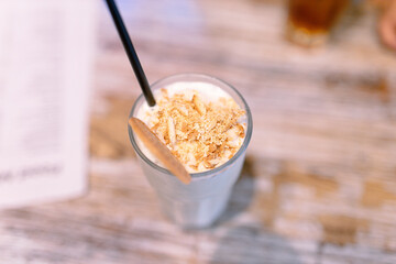 Iced latte coffee, placed on a table in a cafe. To view for background