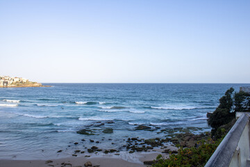 Vibrant Bondi Beach scene: sun-soaked waves, people swimming, and enjoying the lively atmosphere....