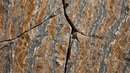 Rock texture with cracks. Close-up. Rough mountain surface. Stone granite background for design. Nature.
