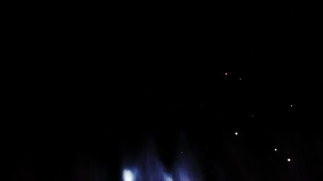 Brilliant burst of colorful fireworks illuminating the night sky, radiating golden and silver streaks with sparkling lights, creating a celebratory and festive atmosphere against the dark night sky