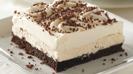 Delicious chocolate brownie dessert layered with creamy white frosting and chocolate sprinkles.