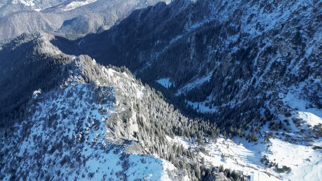 Aerial view of the snowy Malaiesti valley and trail on Bucegi Mountains in central Romania