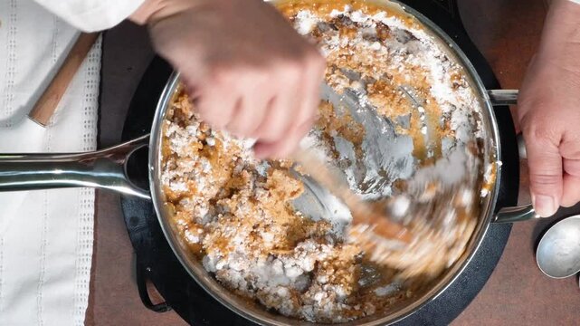 Making peanut butter fudge for a sweet treat.  Made with ingredients such as peanut butter, confectionery sugar, butter and topped with chocolate candy pieces.  No bake peanut butter dessert.