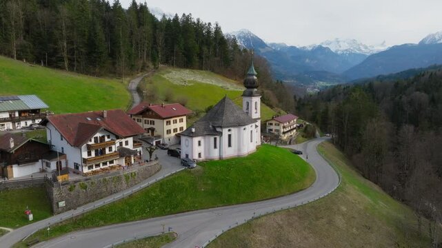 Maria Gern Church in Berchtesgaden, Bavaria, Germany, iconic rural church amidst alpine scenery, aerial pullback and rise