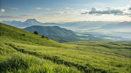 Obraz premium Breathtaking view of a grassy hill with a mountain range in the distance, natural beauty, nature, mountains, grassy hills