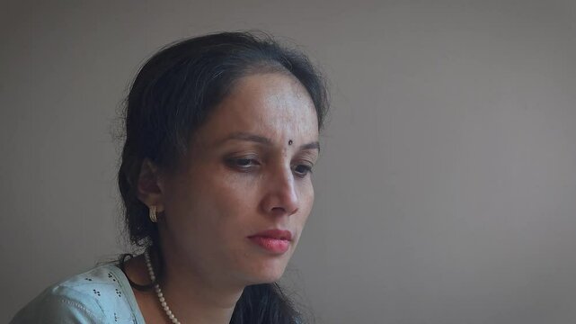 A young Indian Woman is crying. A young actor is doing crying acting in camera in studio light. 