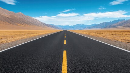 Fototapeta premium Open Highway Stretching Through Barren Landscape Under Clear Blue Sky and Majestic Mountains in Background
