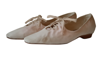 These gentle ballet flats, crafted from soft fabric, rest serenely, highlighting their vintage charm