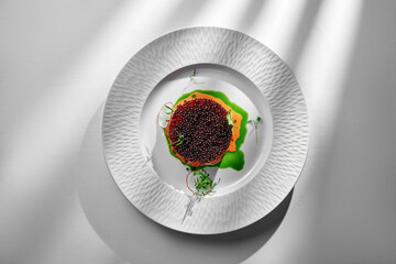 A close-up of a salmon tartare, showcasing the silky texture of the raw salmon and the pop of the...