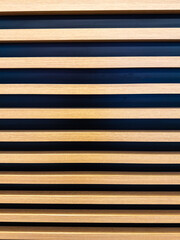 Fototapeta premium Interior wall oak slats on a black background are a little different. Side views of the lamellar wall.