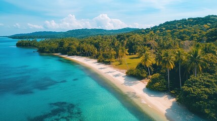 Tropical island with green hills and cliffs, surrounded by turquoise waters and small waves hitting the shore.