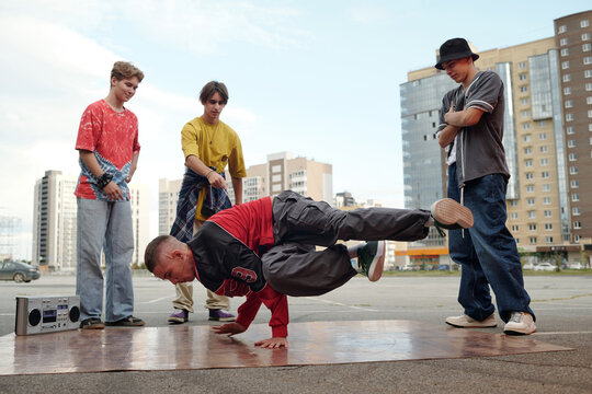 Breakdancing Performers Displaying Street Dance Skills Outdoors
