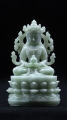 Intricate jade statue of a seated deity with serene expression on a lotus pedestal