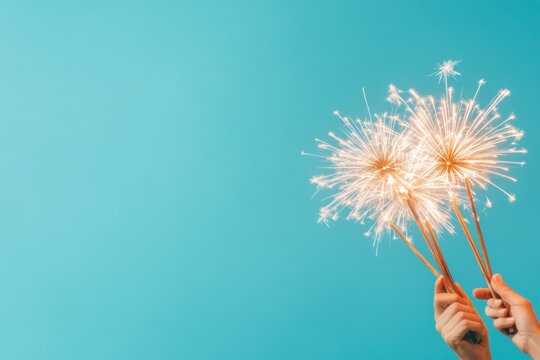 Vibrant Celebration Vintage Sparkler Fireworks Against Cyan Backdrop for Festive Branding and Dynamic Event Marketing - Captivating Holiday Atmosphere Promotion