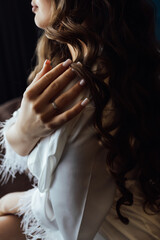 Obraz premium A tender bride strokes her body with her hands and sensually touches her skin. Sensual moment