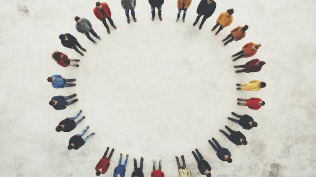 Aerial view of diverse people forming a circle on a light surface.