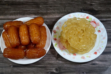 Desserts of Egyptian Meshabek rounded sweet made of a deep-fried crunchy batter soaked either in honey or sugar syrup, and Balah el Sham or Egyptian Choux Pastry crispy and tender choux pastry