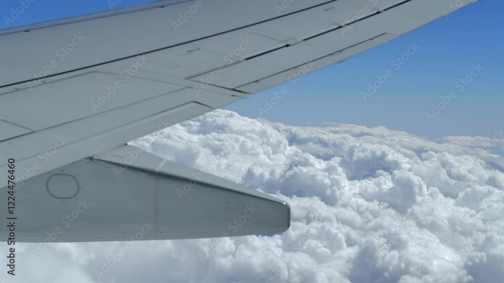 Poster close up view of airplane trailing edge during flight above the clouds