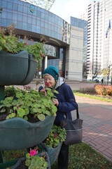 Portrait of an active elderly lady 89 years old on a walk in the city