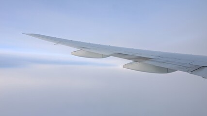 Airplane wing soaring through the sky