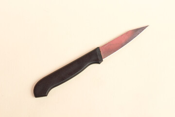 Close up of sharp kitchen knife with black handle isolated on white background.