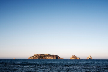 beautiful seascape with Medas islands in the middle of the sea with clear sky and sunlight shining bright, concept of peaceful and serene landscape, copyspace for text