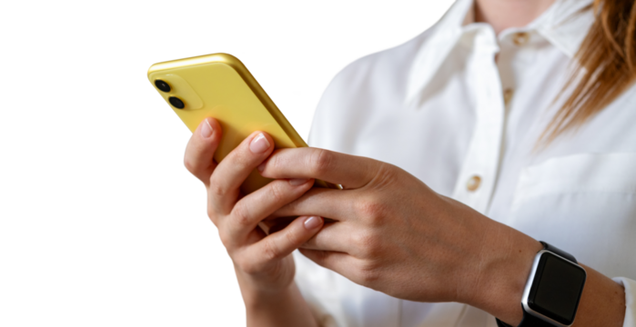 Yellow phone in hands of businessperson wearing white shirt
