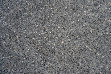 Black gravel stone terrazzo wall background.