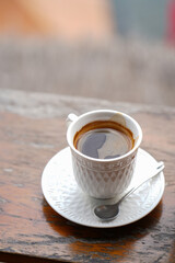 A cup of black coffee on a table.