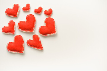 Red hearts on white background. Isolated hearts on white background. Valentine's Day background. Red felt hearts.