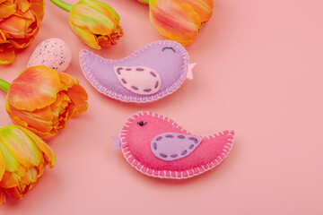 Gentle Easter composition with tulips flowers and handmade felt birds. Traditional elements