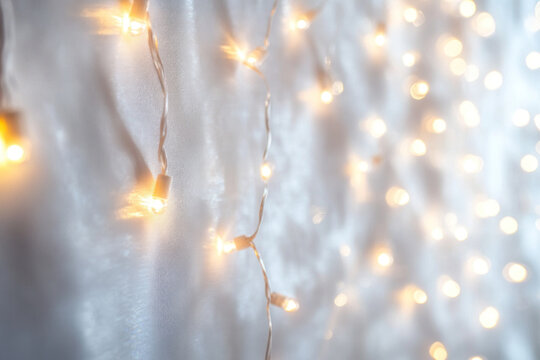 Close-up of a string of twinkling lights against a dark background, creating a warm and festive atmosphere. - Powered by Adobe