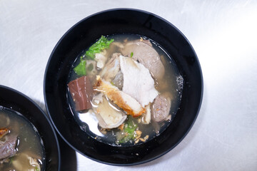 Boiled pork entrails and blood jelly soup in black bowl you can eat couple with rice. Healthy and rich in iron and protein