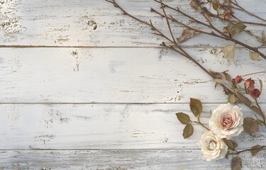 A rustic white wooden background with dried roses and delicate floral elements, creating a vintage and romantic aesthetic. Perfect for wedding designs, invitations, and artistic compositions.