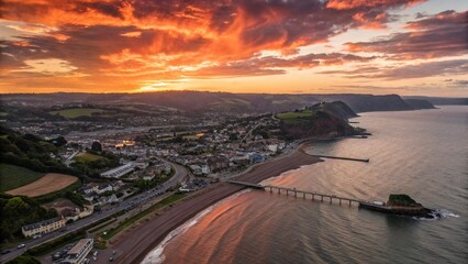 Fototapeta premium Dramatic Silhouette Aerial Drone View of Teignmouth, Devon Coastline at Sunset