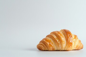 Golden croissant with flaky layers elegantly placed against mini