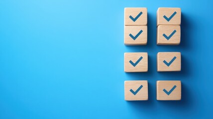 Top view of abstract wooden blocks with check marks in graphic design studio - conceptual art on blue