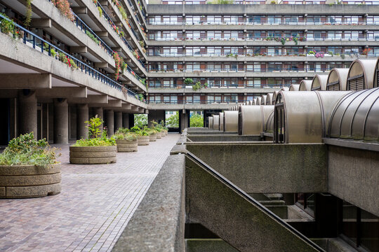 A close view of the Barbican Estate in London, showcasing its striking brutalist architecture. This iconic landmark merges raw concrete design with thoughtful urban green spaces