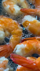 Sizzling shrimp frying in oil capture the essence of seafood cuisine, ideal for summer barbecues or culinary concepts
