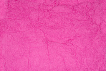 Obraz premium Pink crinkled tissue paper background. Recycling gift packaging for holidays Valentines