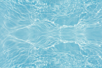 Blue water with ripples on the surface. Defocus blurred transparent blue colored clear calm water...
