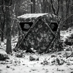 Fototapeta premium Camouflaged Hunting Blind in Snowy Winter Woods