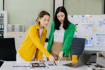 Creative digital development agency. developer team brainstorming on their project with laptop,...