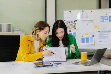 Creative digital development agency. developer team brainstorming on their project with laptop,...