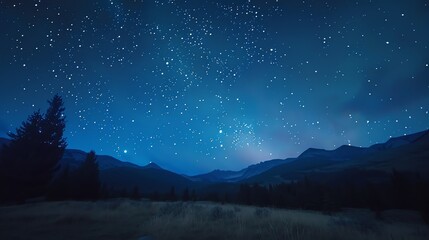Obraz premium A night sky full of stars over a mountain range.