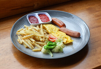 Mix platter contains french fries, egg, and sausages.