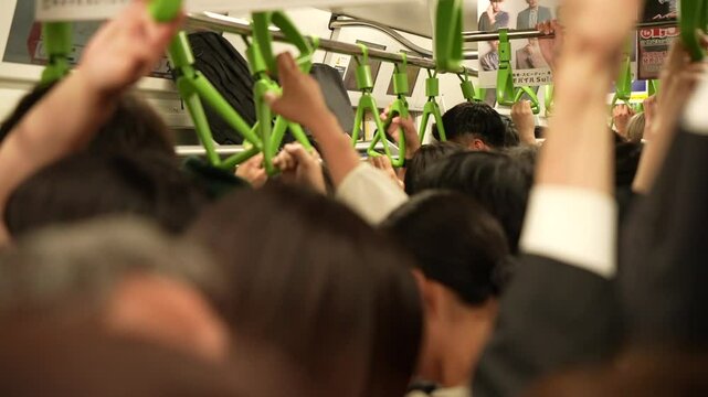 View of inside crowded metro train during rush hour, Tokyo, Honshu, Japan