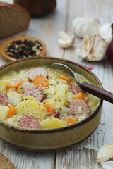 A bowl with traditional German potato soup with sausages
